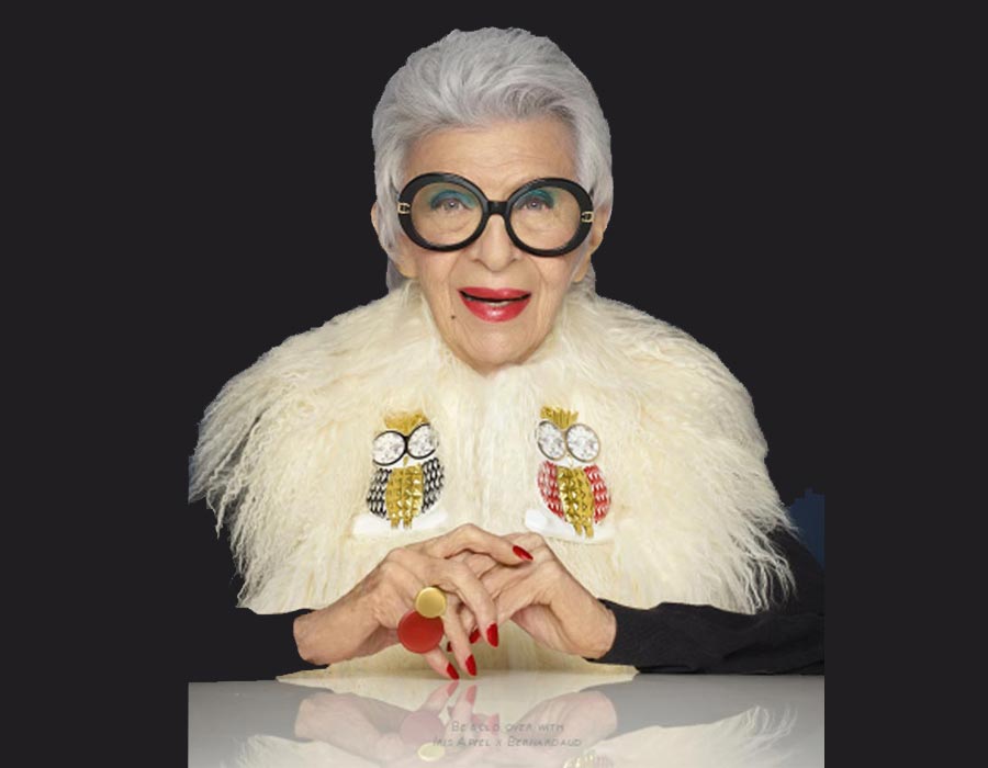 Iris apfel wearing her own creation for Bernardaud, a porcelaine owl brooch